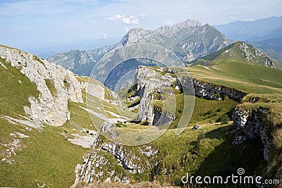 Picteresque view of a high cliff, rocks, green hillsides, mountain in North Osetia Russia Stock Photo